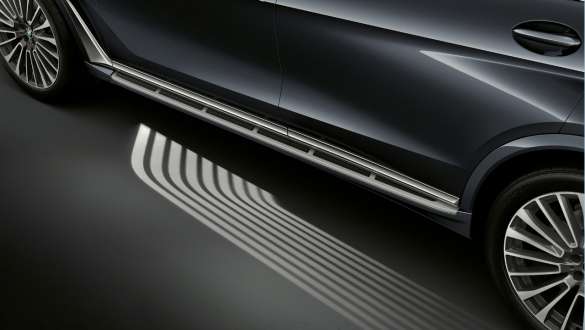 „Covorul” luminos de întâmpinare al modelelor BMW X7 M Imagine înclinată de sus cu proiecţia „covorului” luminos de întâmpinare în faţa portierei conducătorului auto al modelelor BMW X7 M, G07