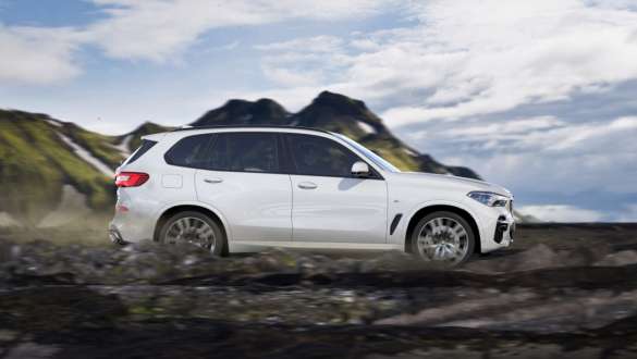 Modul „off-road” „xRocks” al BMW X5 Imagine din lateral cu BMW X5, G05, 2018, în Alb Mineral metalizat, rulând pe teren stâncos, mod de condus „xRocks”