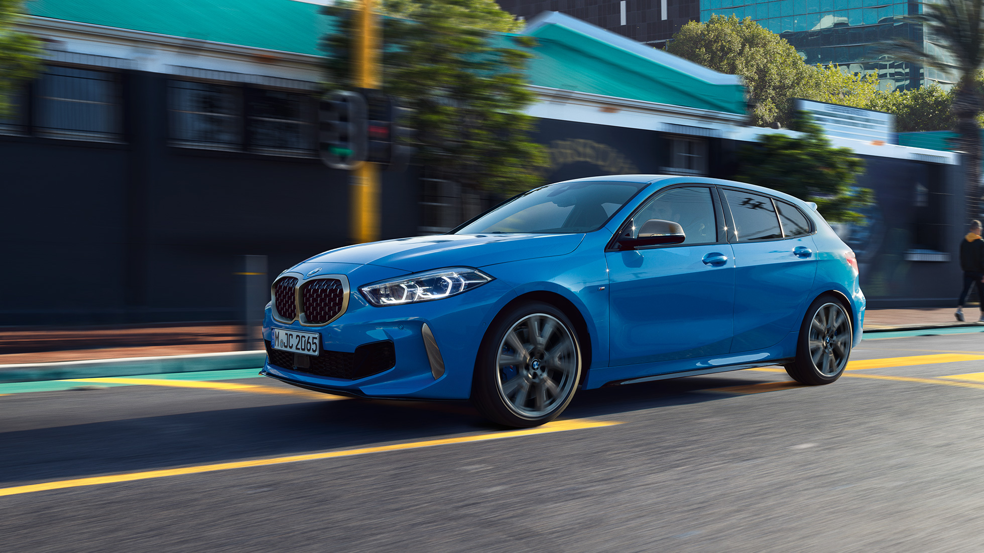 Imagine cu trei sferturi din partea laterală a BMW Seria 1. Imagine cu trei sferturi din partea laterală a BMW Seria 1 în Albastru Misano metalizat, rulând.