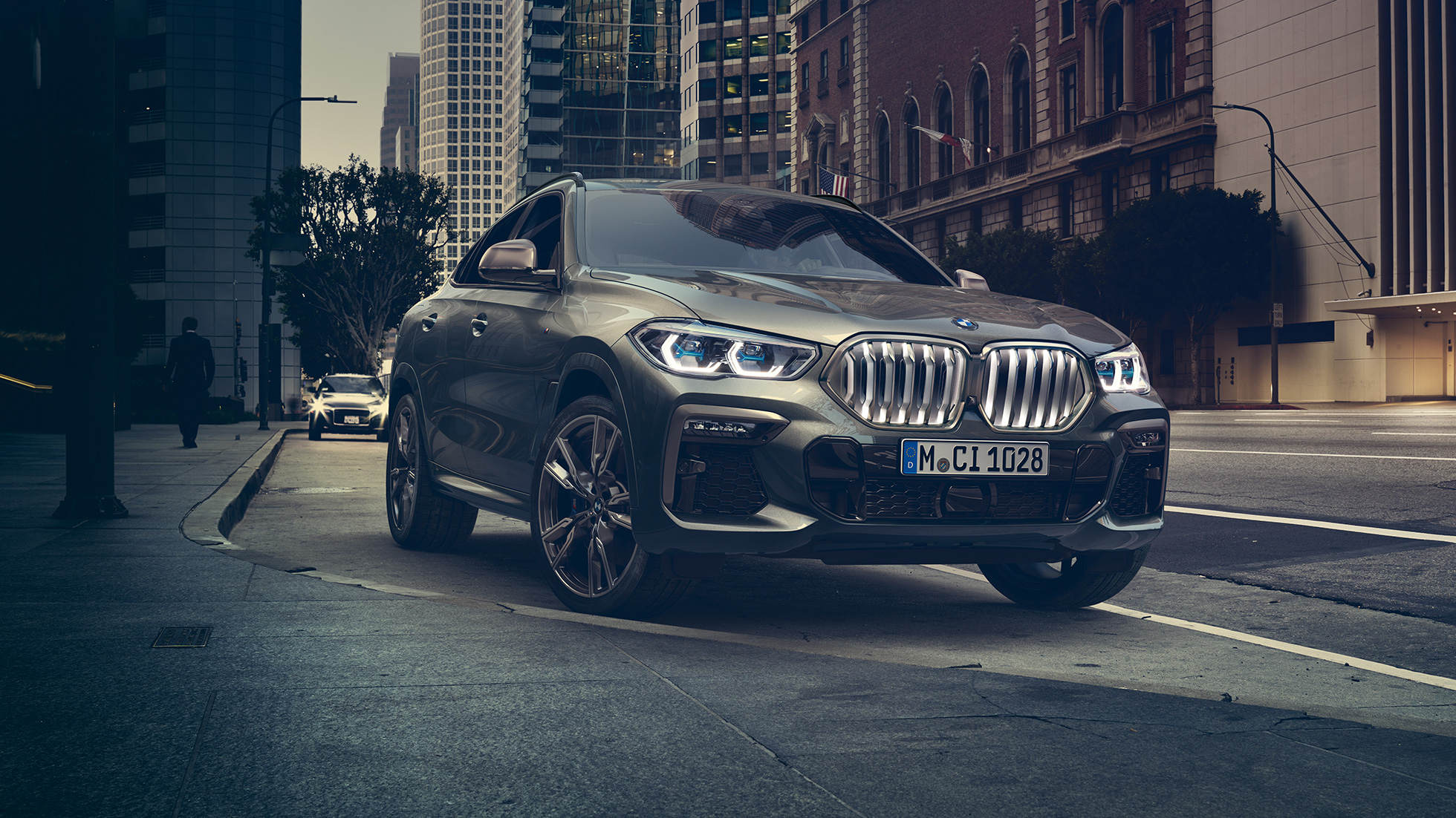 Suspensia M adaptivă „Professional” a BMW X6. Imagine cu trei sferturi din partea frontală a BMW X6, într-un mediu urban.