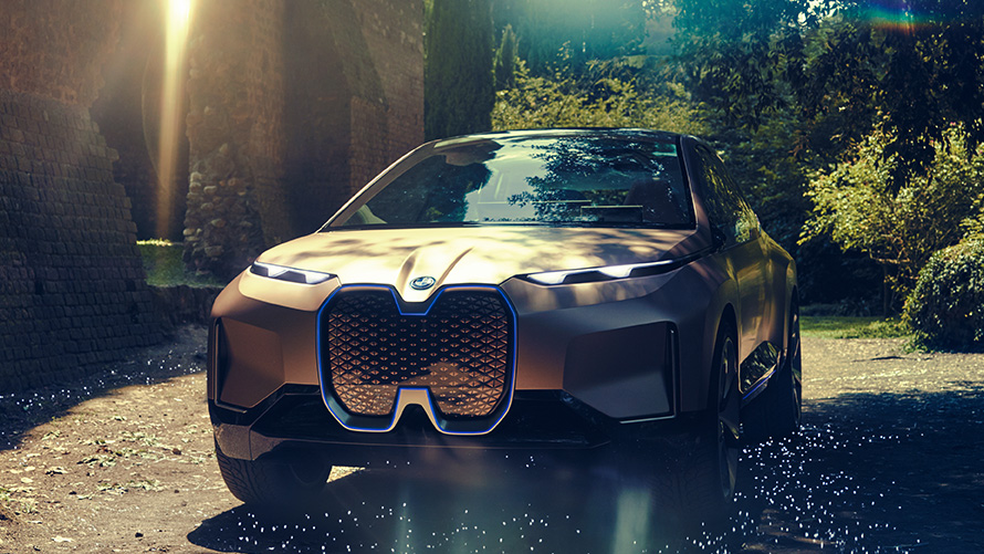 BMW Vision iNEXT în faţa unei păduri Imagine cu trei sferturi din partea frontală a BMW Vision iNEXT în faţa unei păduri